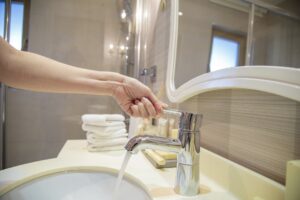 opening a water tap in the bathroom faucet, stainless steel faucet with lever handle